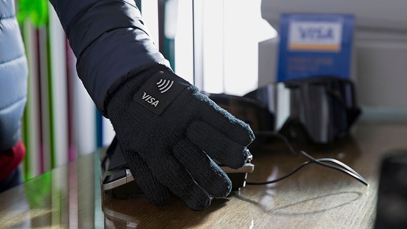 An olympic athlete wearing and promoting a Visa wearables glove with pin for easy checkout.